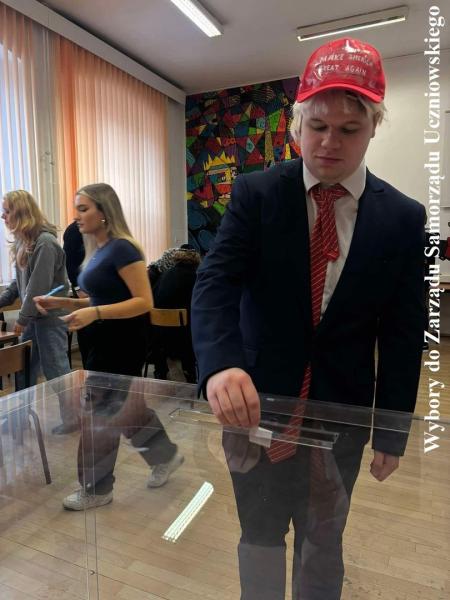 Uczeń wrzucający kartkę ze swoim głosem do urny