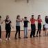 Uczniowie szkoły podczas prezentacji tańca na sali gimnastycznej.